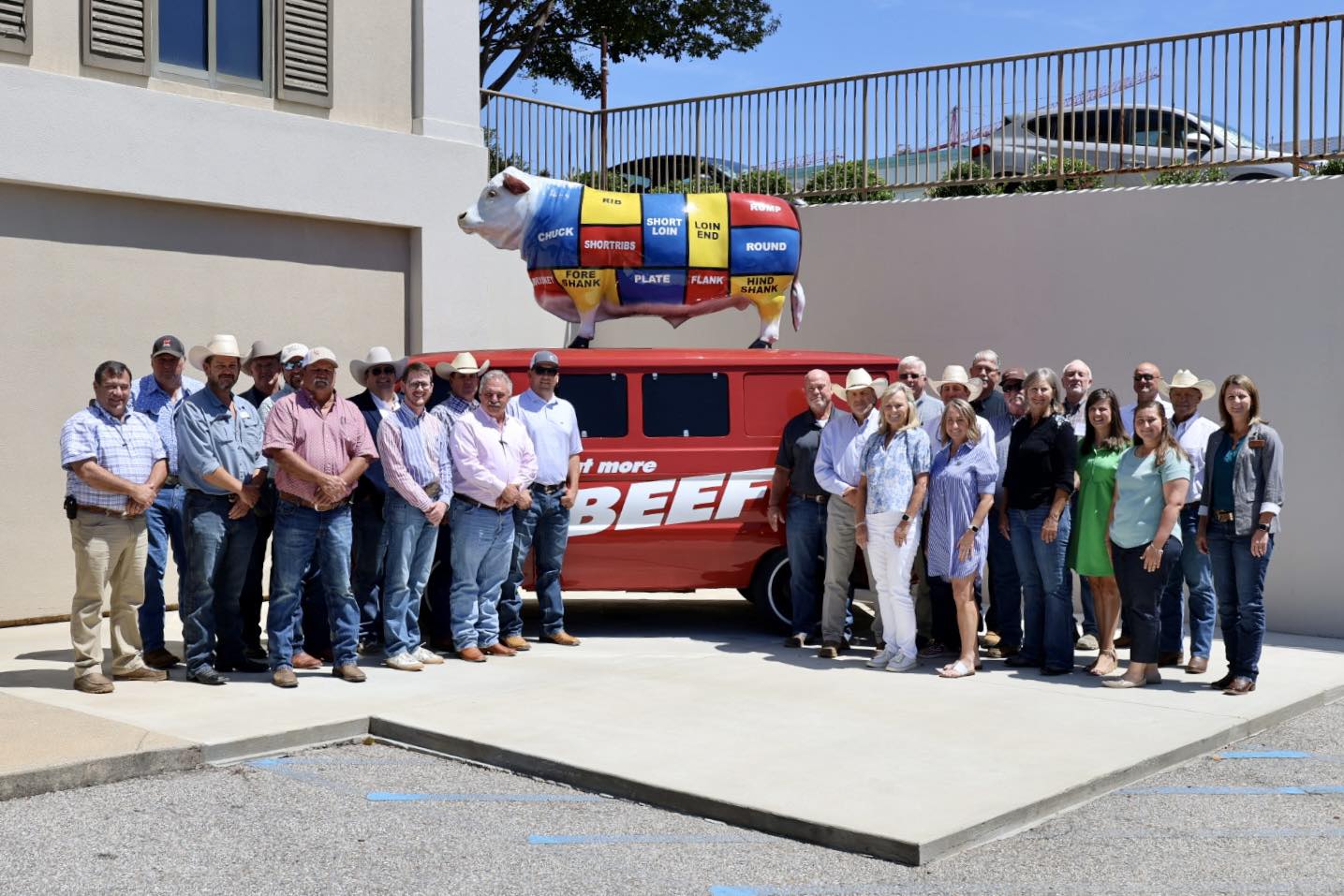 Group of people standing infront of a van