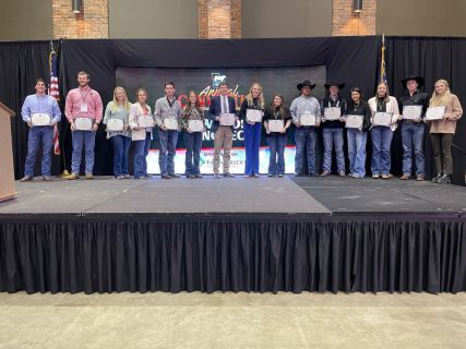 Group of people stnding up with their awards